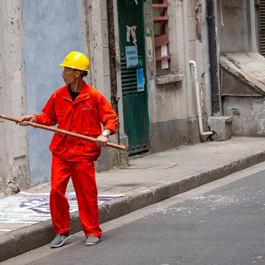 Worker carrying out surface treatment on a residential building wall